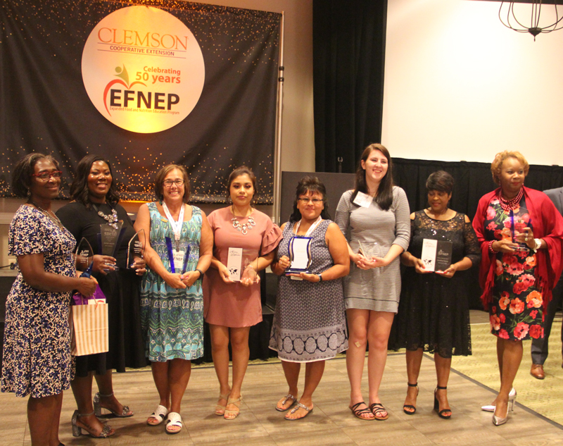 group photo of efnep participants in front of a 50th anniversary banner