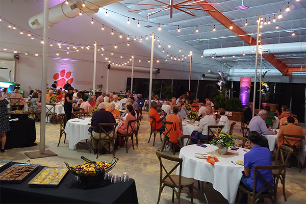 cattle barn complex with people eating in chairs