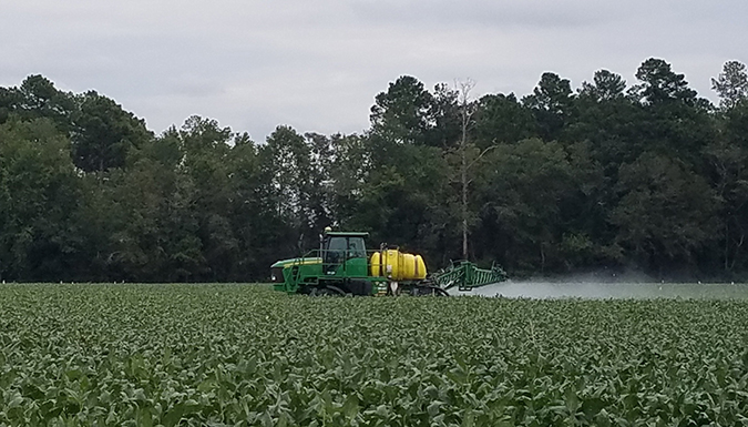 Tractor spraying pesticides.