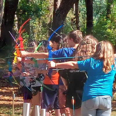 ffa middle school camp group aiming bow and arrows at targets