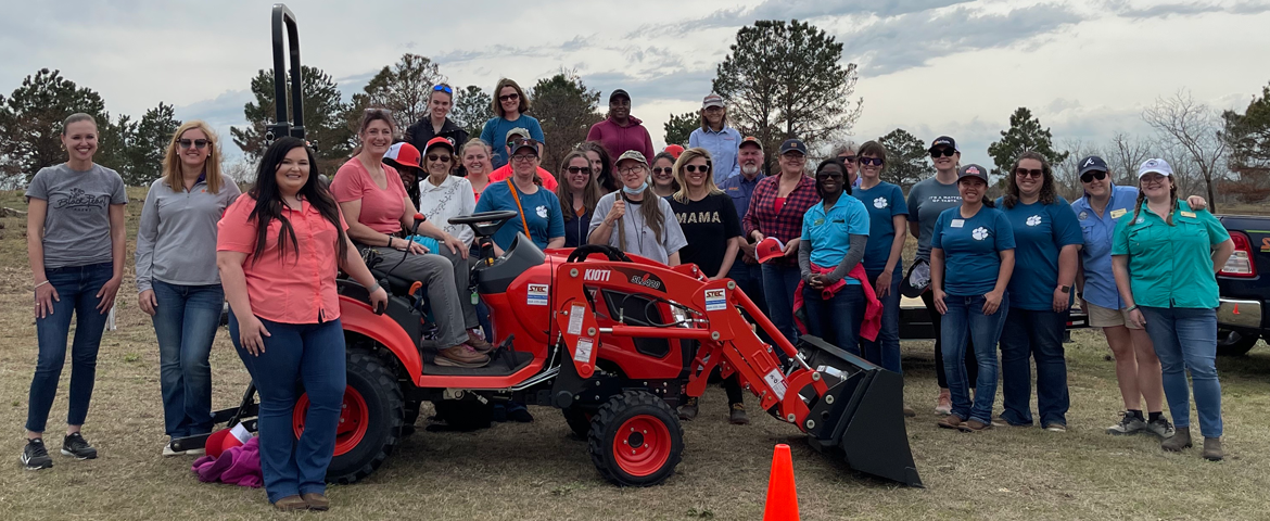 group photo of female South Carolina Women's Agricultural Network participants in front of a tractor