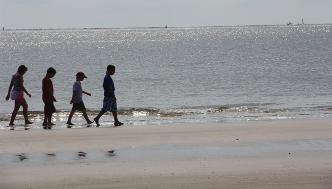 kids walking on the beach on a summer day