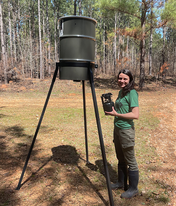 Elizabeth Saldo standing nex to a wildlife feeder. (Photo by Elizabeth Saldo)