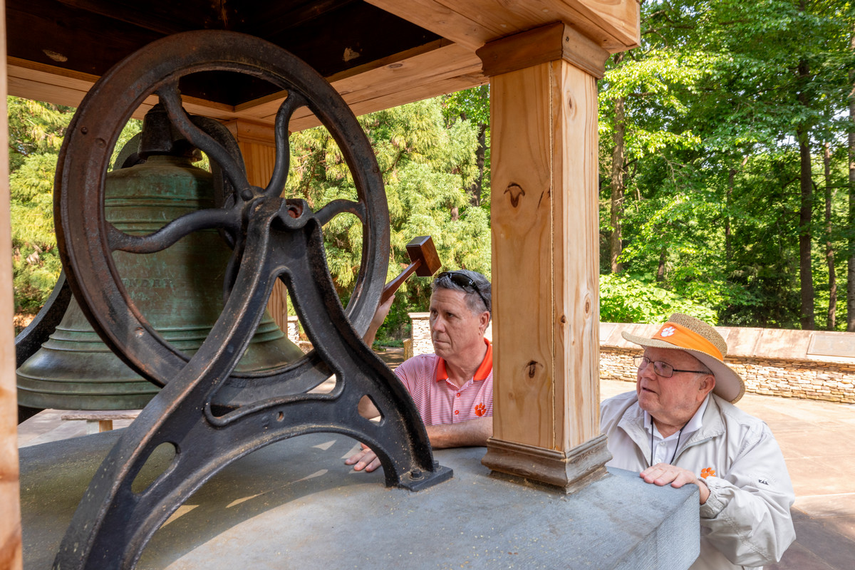 two men ring the bell in the Heritage Garden at the South Carolina Botanical Gardens