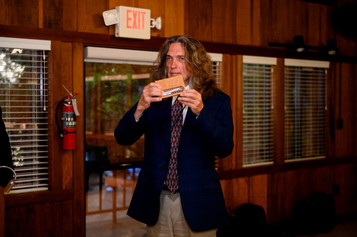 man holdin up a corkscrew