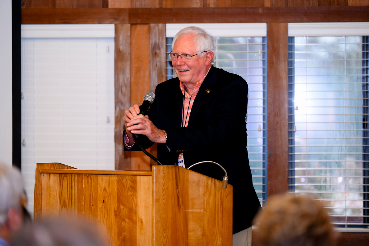 man speaking from a lecturn at the Class of '39 reunion dinner