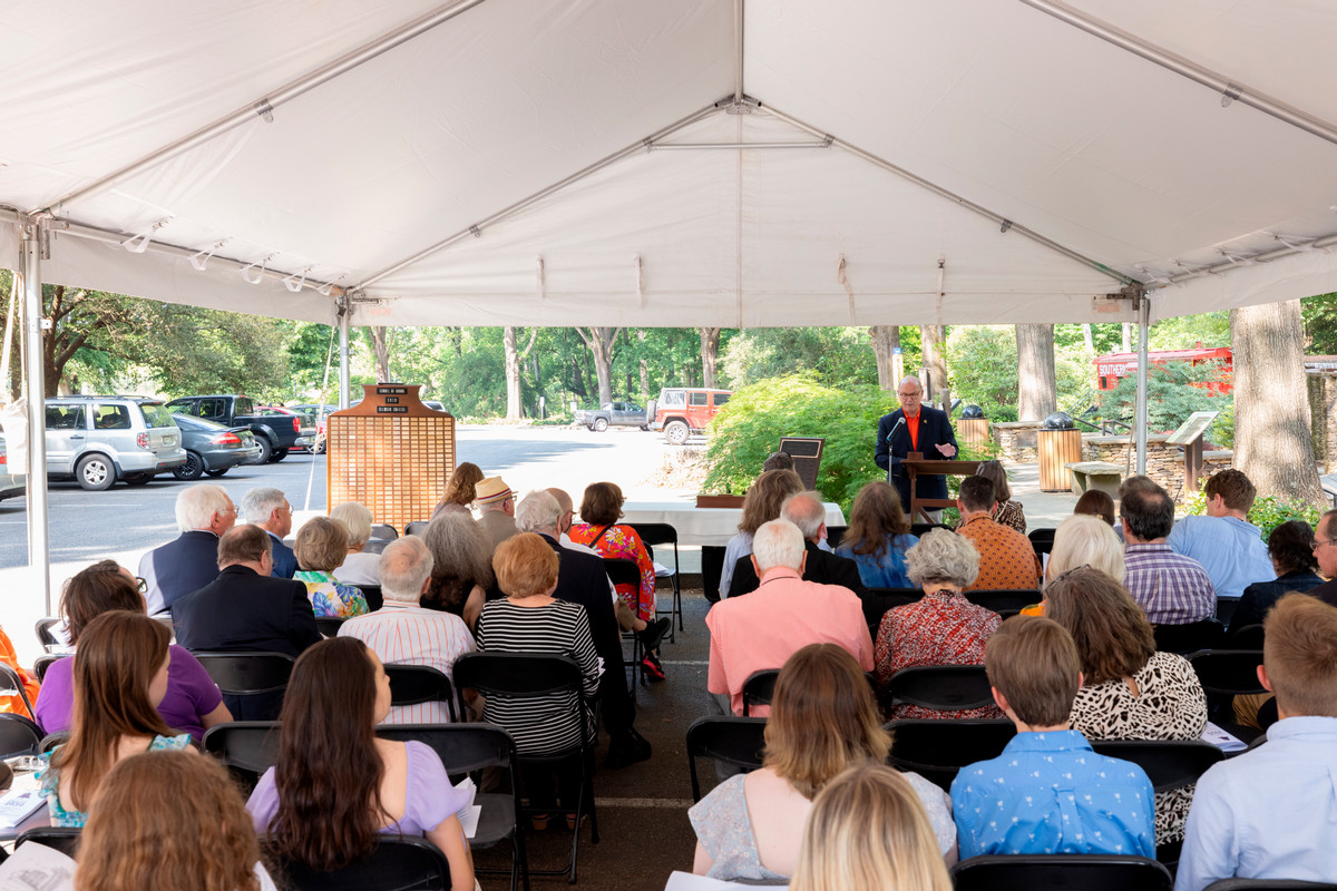man addresses attendants of the memorial service