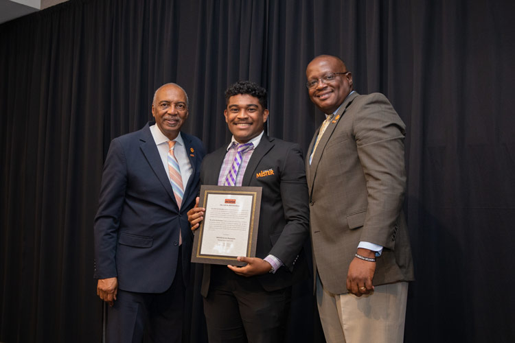 a student from the call me mister program receives their certificate and jacket