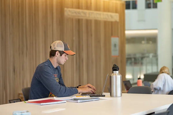 a student sits at a table doing class work