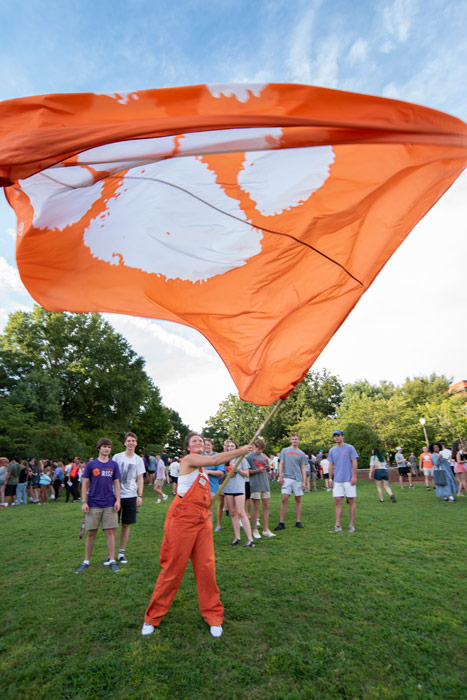 a first year student waves a large Clemson flag