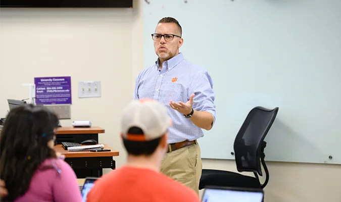 A professor Instructs a class of students