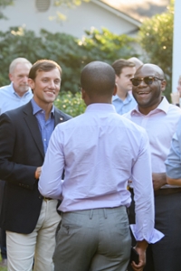 Three men chatting with one another at an event