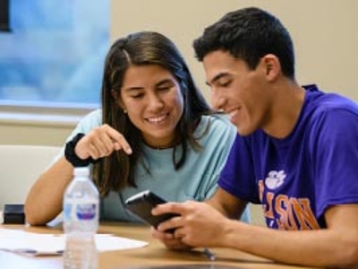 Two students work together at a shared table