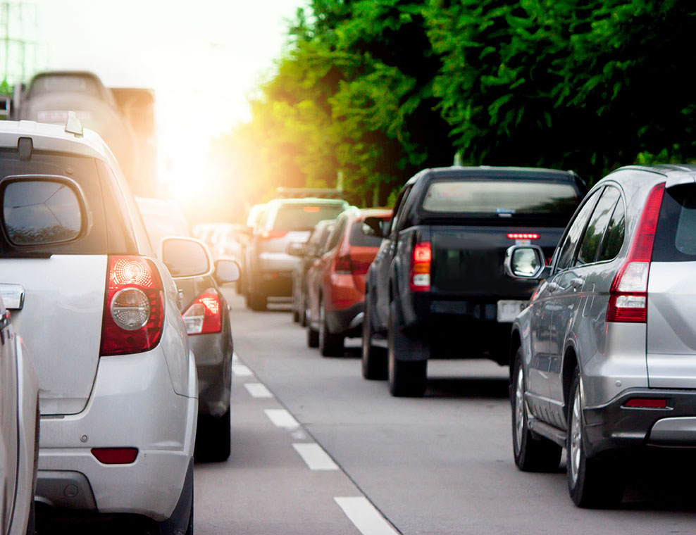 Traffic congestion on a busy road during sunset.