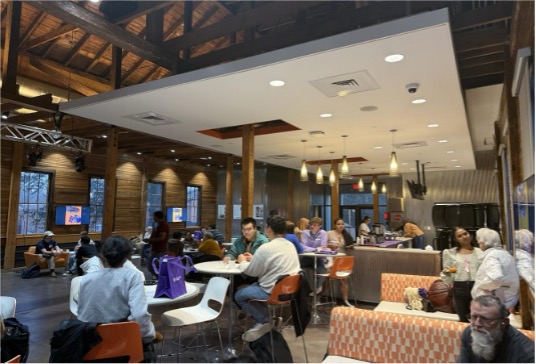People conversing at tables in a relaxed setting