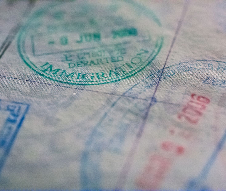 Close-up of immigration stamps on a passport.