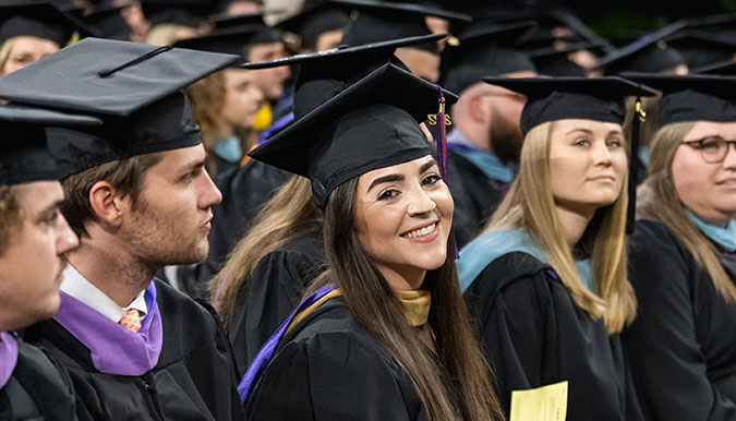 Woman smiling during the Master's graduation ceremony.