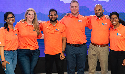 five members of graduate student government link arms after an event