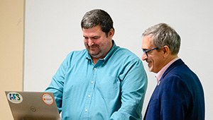 dean and student look at laptop computer