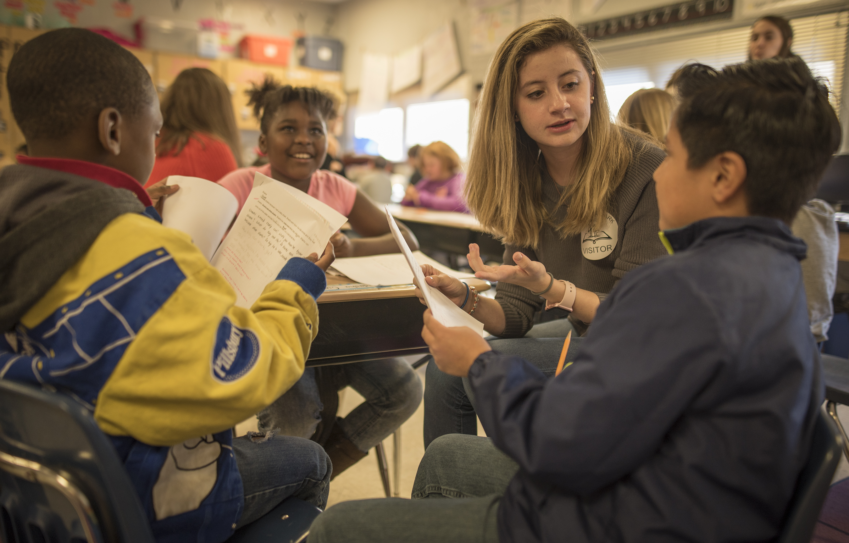 Teacher reading books with kids