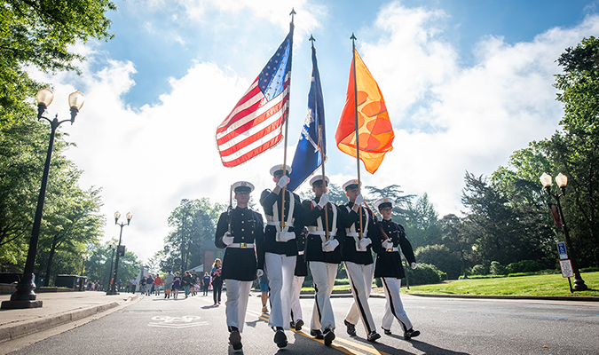 Clemson ROTC Pershing Rifles honor guard carrying the US flag, SC State flag, and Clemson flag during the 2023 Mile of Honor walk