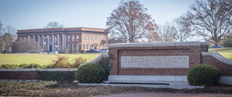 Clemson University sign with Sikes Hall in the background