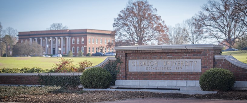 Clemson University sign with Sikes Hall in the background