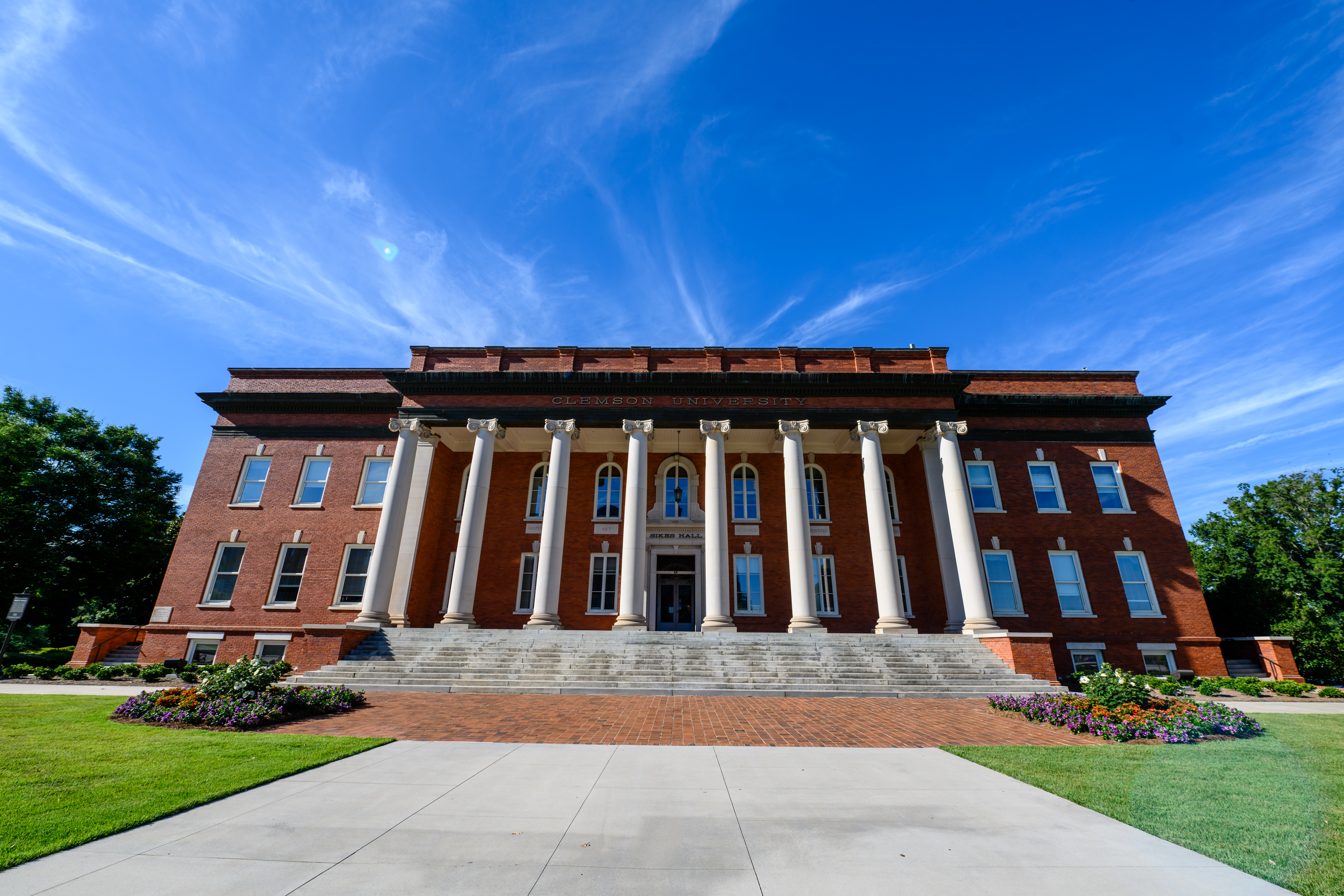 Sikes Hall on Clemson's campus with a bright blue sky.