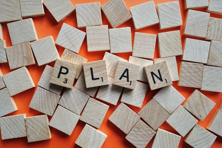 Board game letters spelling the word PLAN