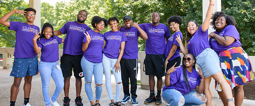 Group photo with several young adults all wearing purple Clemson Emerging Scholars shirts. 