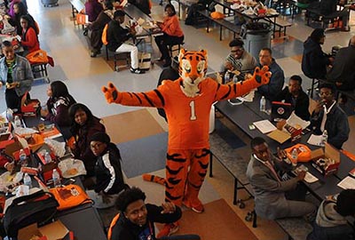 Tiger Mascot poses in a crowded room of students