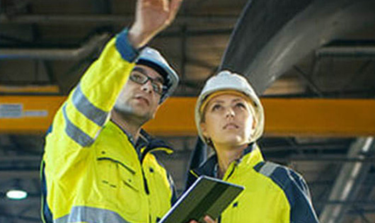 2 workers in hardhats discussing plans