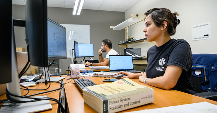Two grad students working at a computer