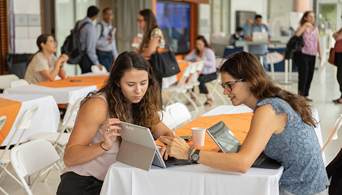 Faculty collaborate over a tablet during the New Instructor Conference.