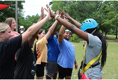 Group of kids giving high-fives.