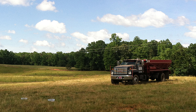 Large farm truck sitting in field.