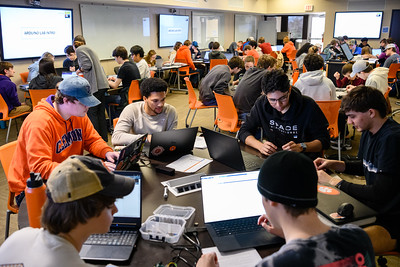 students at tables in a classroom