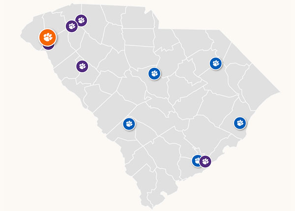 Map of South Carolina highlighting various locations with paw print icons representing Clemson University.