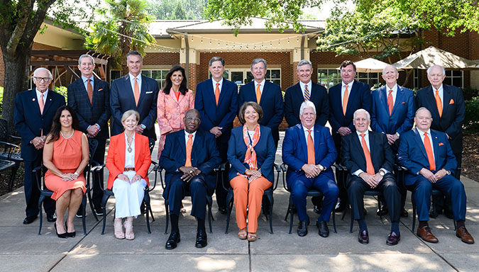 All trustees sitting outside in front of trees
