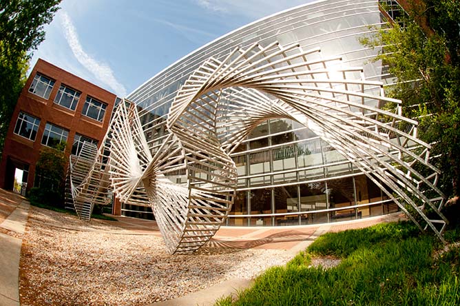 A spiralling metal sculpture by Linda Howard.  /the piece is called Six Degrees of Freedom and resembles spiral archways.