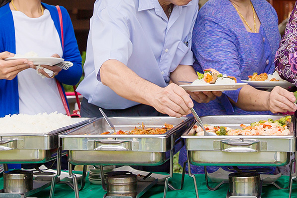 Guests serving themselves from chafing dishes
