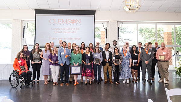 Group photo of award recipients at Clemson University's Spring Awards ceremony, featuring diverse individuals holding plaques.