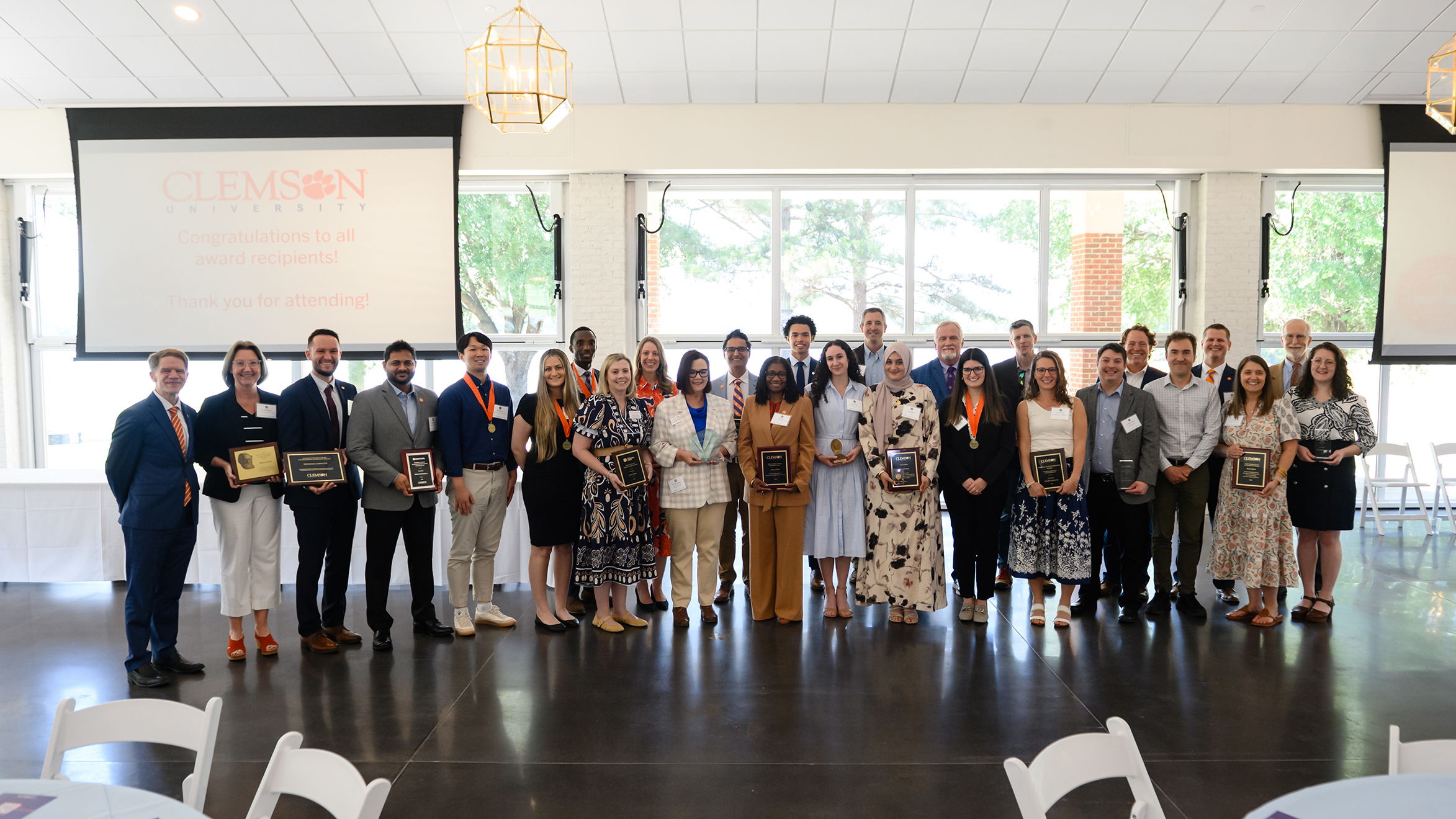 Group photo of award recipients at Clemson University's Spring Awards ceremony, featuring diverse individuals holding plaques.