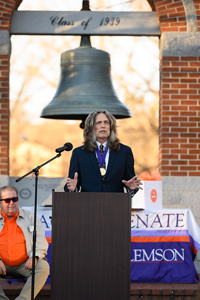 Winner of Class of 39 Award addresses an audience outdoors at Clemson University.