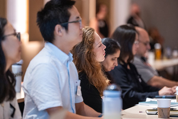 New faculty members listen intently during new faculty orientation.