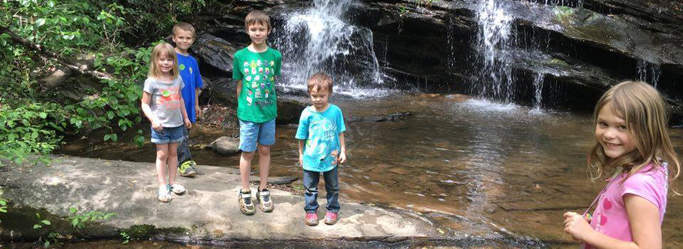 Kids by the waterfall