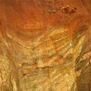 image of gneiss rock that has undergone iron oxidation (rusting)