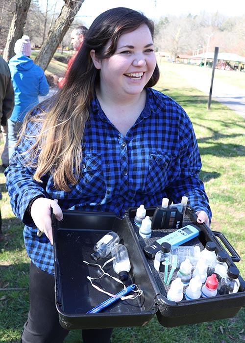 smiling intern holding kit