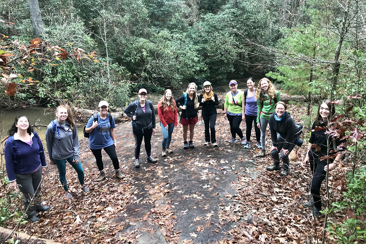 Women in Water Outdoors participants gather for a photo while on a hike