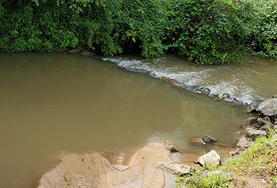 The North Saluda River with heavy sediment with cloudy brownish-green water due to high sedimentation.